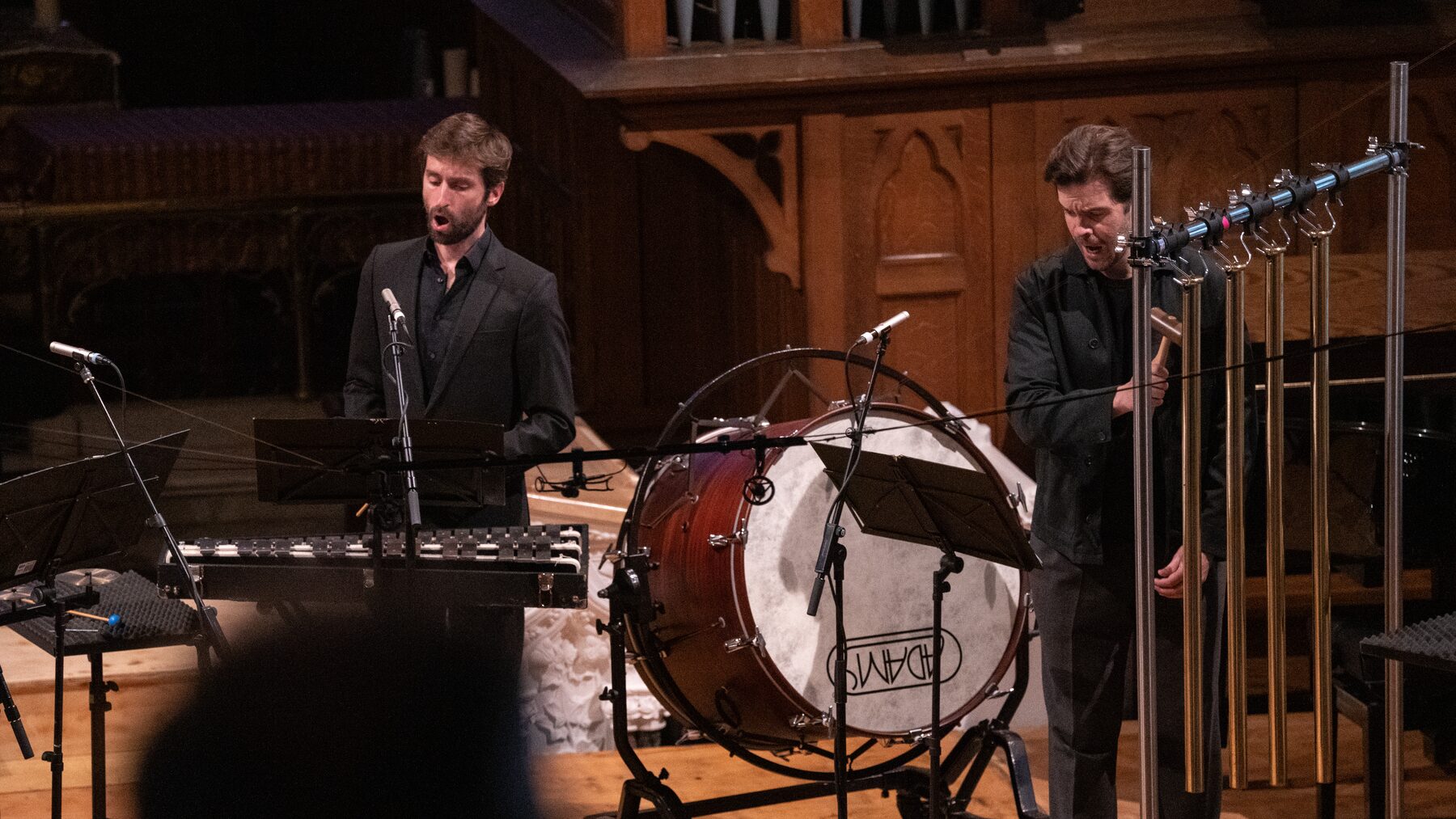Two singers of Damask playing percussion in The Little Match Girl Passion